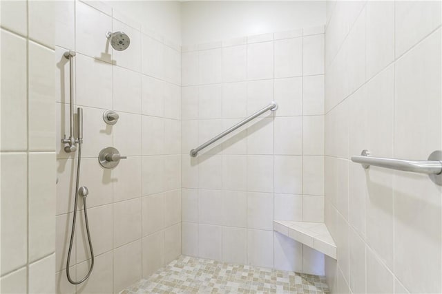 full bath featuring tiled shower