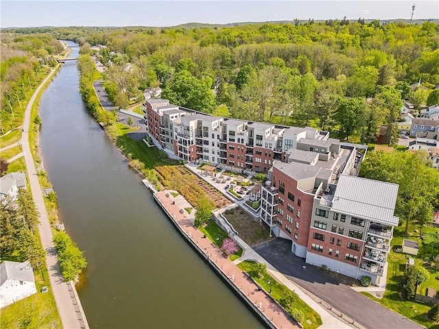 drone / aerial view featuring a view of trees and a water view