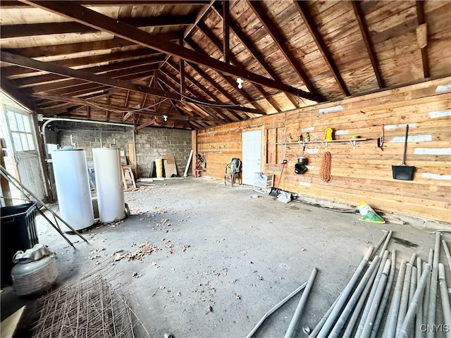 miscellaneous room with lofted ceiling, a garage, and water heater