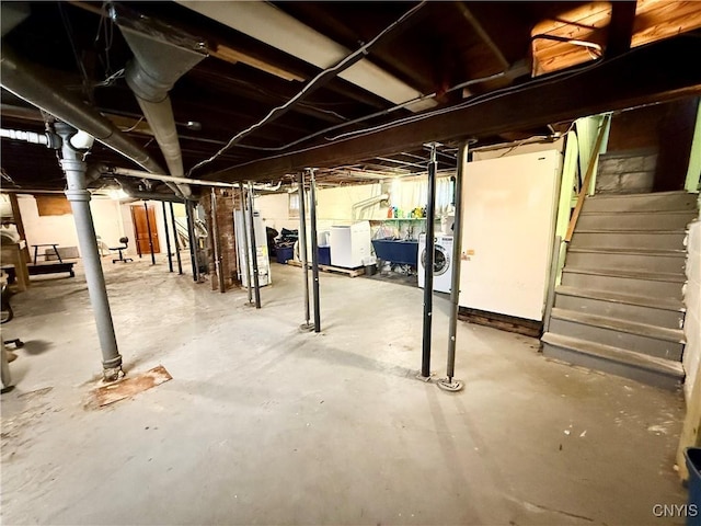 unfinished below grade area featuring a sink, stairway, and water heater