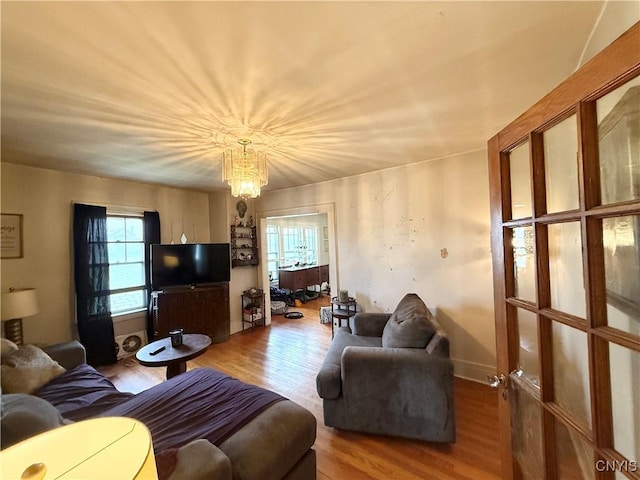 living area featuring an inviting chandelier and wood finished floors