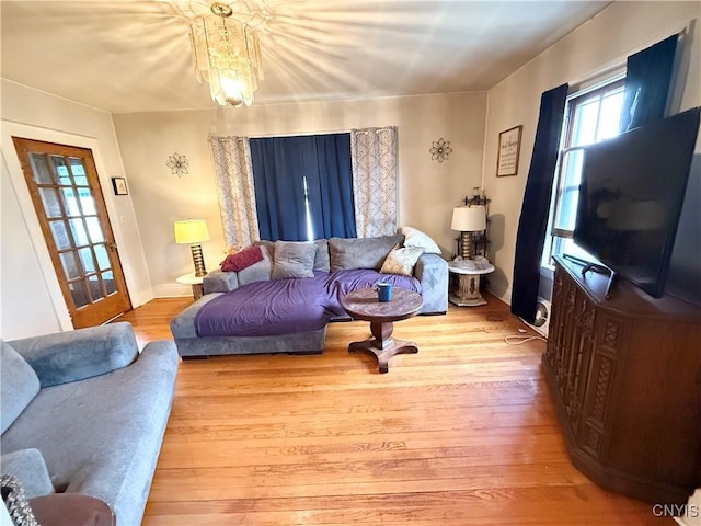 living area featuring an inviting chandelier and wood finished floors