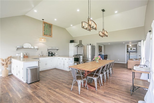 dining room featuring recessed lighting, dark wood-type flooring, high vaulted ceiling, and washing machine and clothes dryer