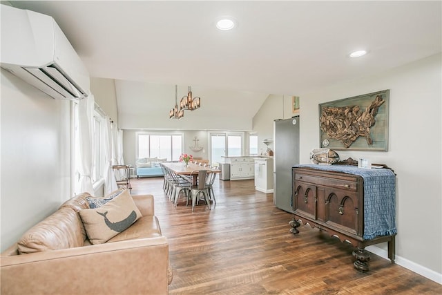 dining space with wood finished floors, a wall mounted AC, lofted ceiling, recessed lighting, and a chandelier