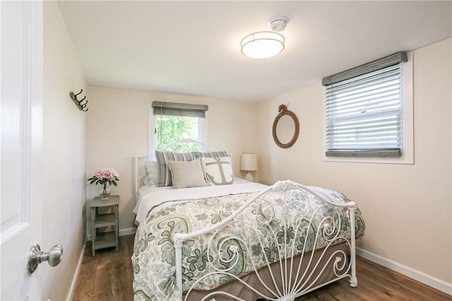 bedroom with baseboards and wood finished floors