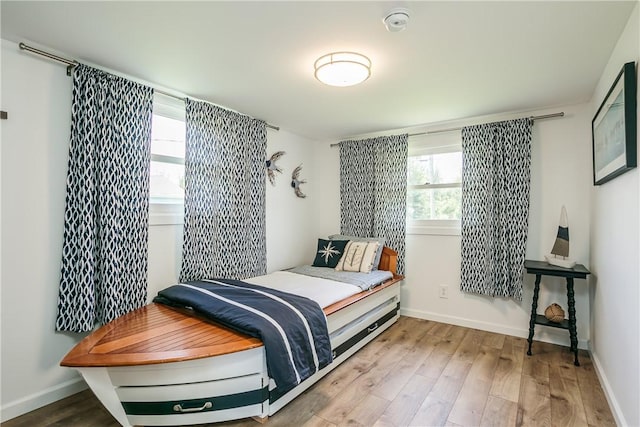 bedroom with wood finished floors and baseboards