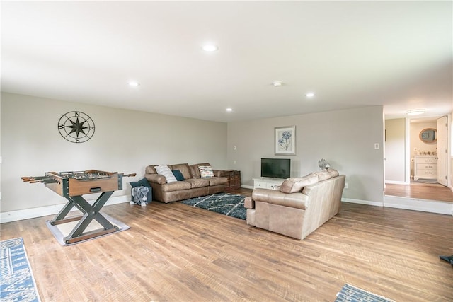 living area with recessed lighting, baseboards, and wood finished floors