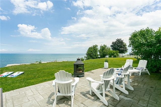 view of patio with a water view and an outdoor fire pit