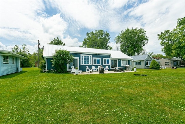 rear view of property with a patio area and a lawn