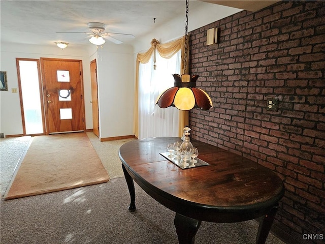 unfurnished dining area with baseboards and brick wall