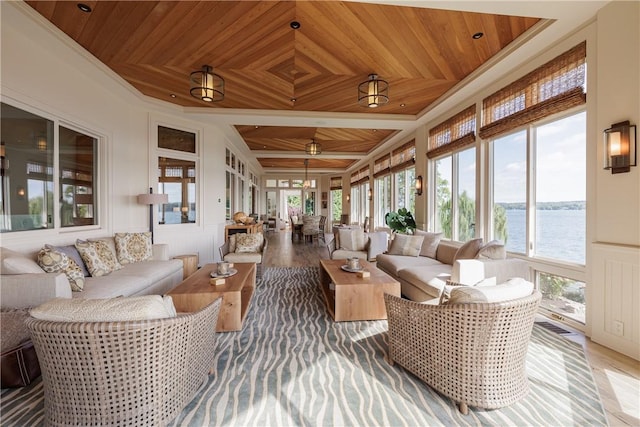 sunroom with wood ceiling and a water view