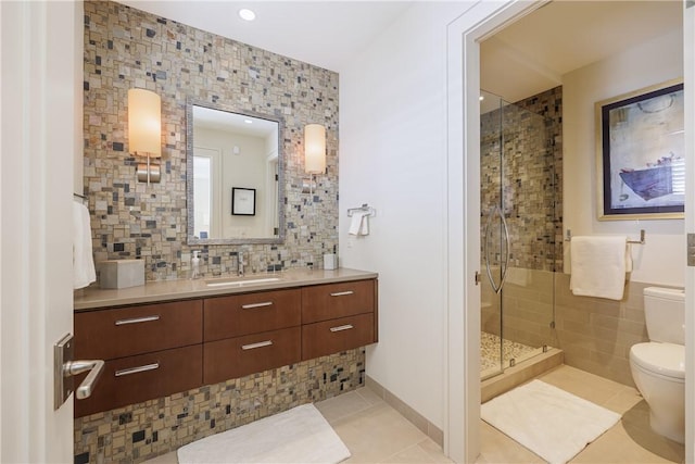 bathroom with tile patterned floors, toilet, tile walls, and a stall shower