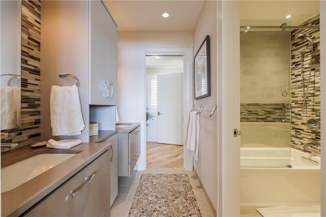 full bathroom with recessed lighting, shower / bath combination with glass door, and vanity