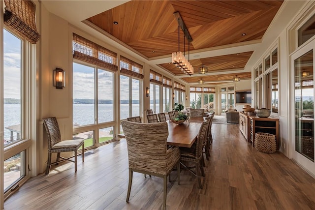 sunroom featuring a tray ceiling, wood ceiling, and a chandelier