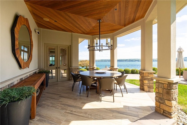 exterior space featuring a chandelier, wooden ceiling, light wood-type flooring, and a water view