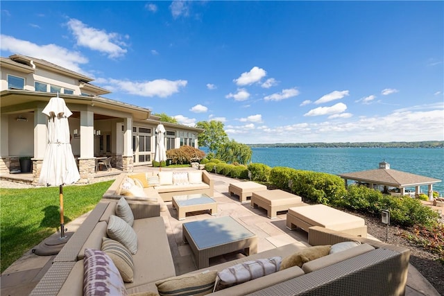 view of patio / terrace with an outdoor living space and a water view