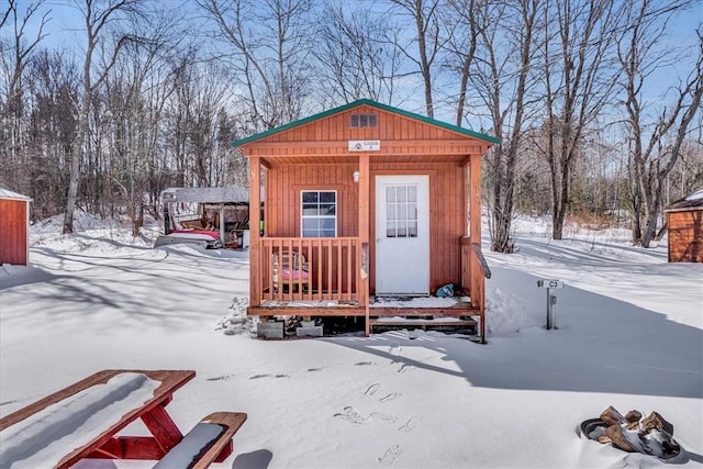 snow covered structure with an outdoor structure