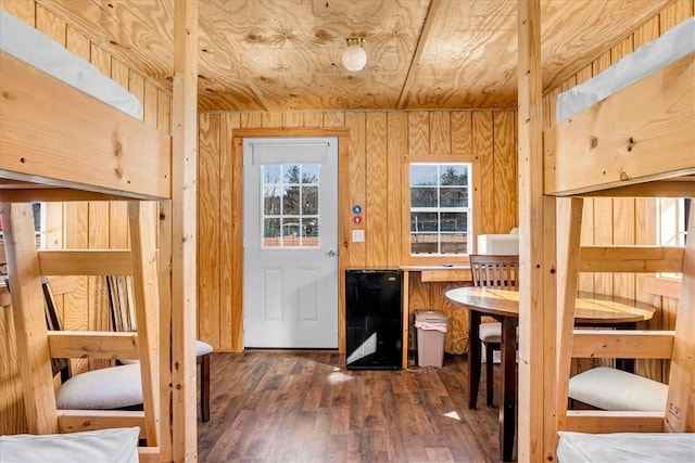 interior space with wood ceiling, wooden walls, and wood finished floors