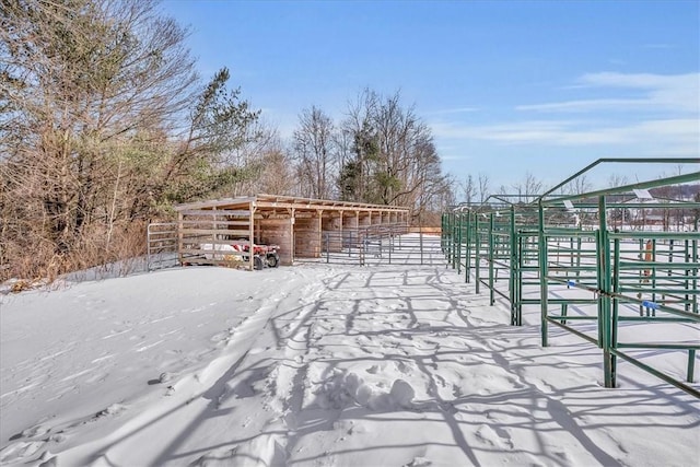 yard covered in snow with an exterior structure and an outbuilding
