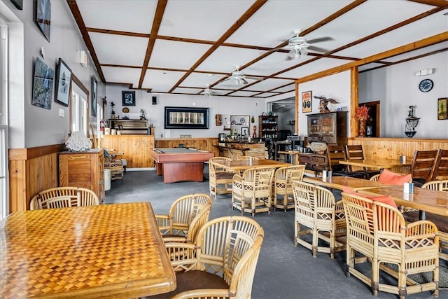 dining room with a wainscoted wall, ceiling fan, billiards, and wood walls