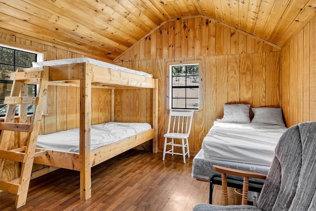 bedroom featuring wooden walls, wooden ceiling, wood-type flooring, and vaulted ceiling