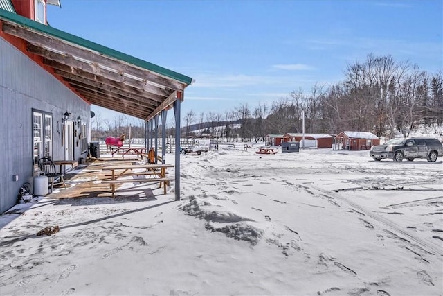yard layered in snow featuring a garage