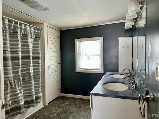 full bath featuring double vanity, visible vents, baseboards, and a sink