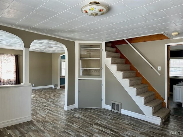 interior space with wood finished floors, a healthy amount of sunlight, and visible vents