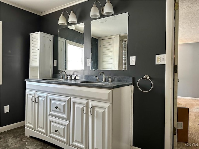 bathroom featuring a sink, baseboards, and double vanity