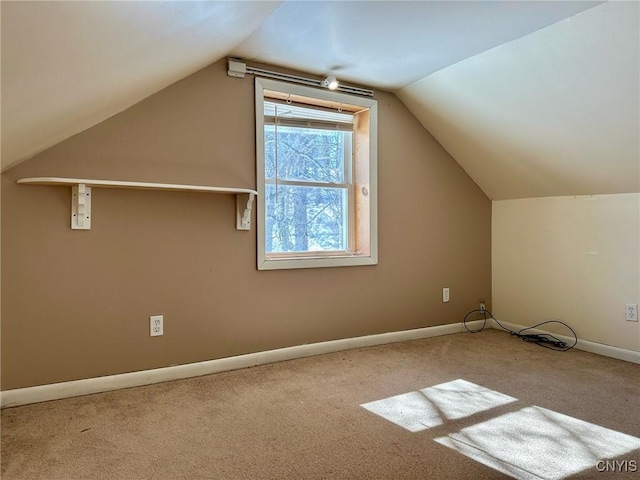 bonus room featuring carpet flooring, baseboards, and lofted ceiling