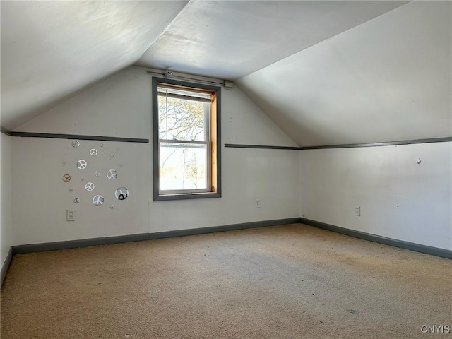 bonus room featuring vaulted ceiling, carpet, and baseboards