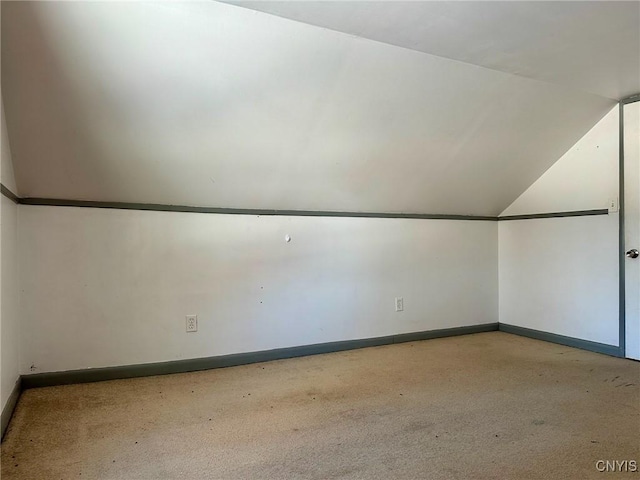 bonus room featuring baseboards and lofted ceiling