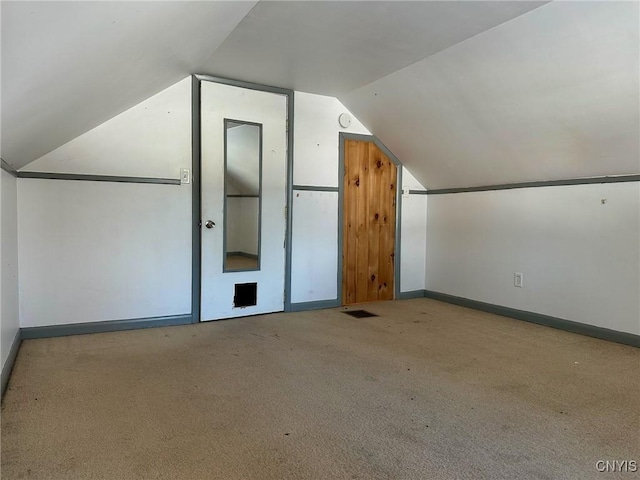 bonus room featuring vaulted ceiling, carpet, baseboards, and visible vents