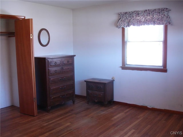 unfurnished bedroom with dark wood-style floors and baseboards