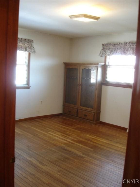 interior space with baseboards and wood finished floors