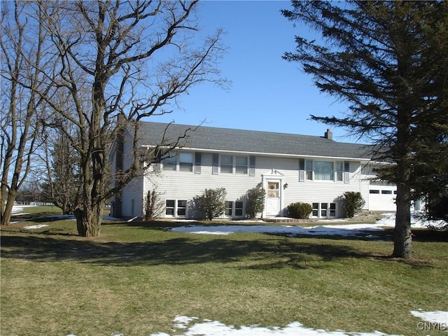 split foyer home featuring a front yard and a chimney