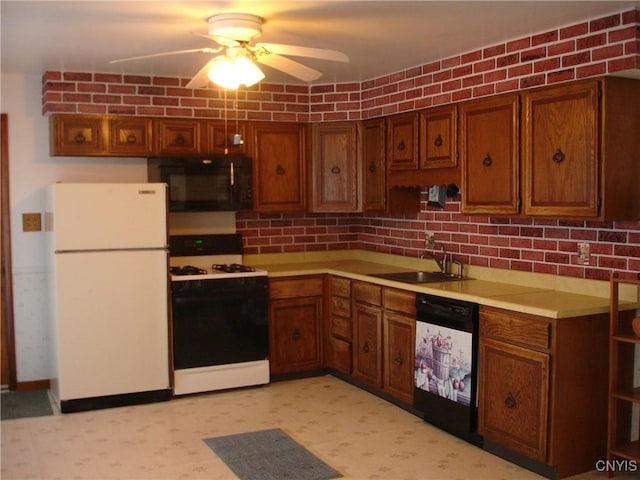 kitchen featuring a sink, freestanding refrigerator, gas stove, black microwave, and dishwashing machine