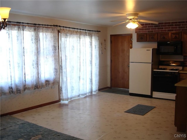 kitchen featuring baseboards, white appliances, light floors, and a ceiling fan