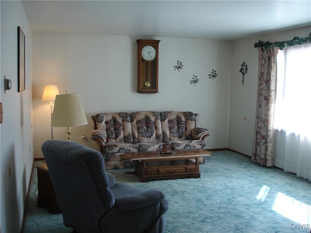 carpeted living area with baseboards