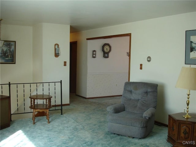 sitting room featuring carpet flooring and baseboards