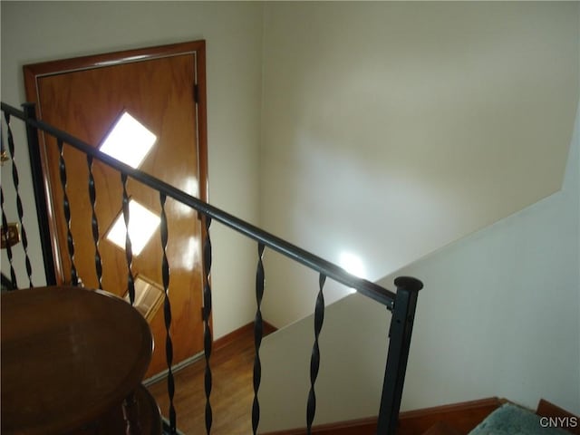 staircase with wood finished floors