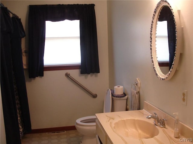 full bath featuring vanity, baseboards, visible vents, tile patterned floors, and toilet