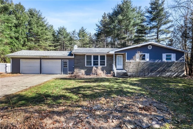 ranch-style home with an attached garage, a chimney, driveway, and a front yard