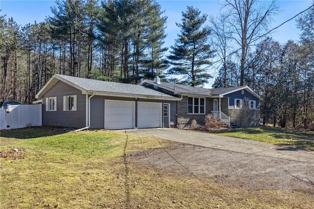 ranch-style home with a front yard, concrete driveway, fence, and a garage