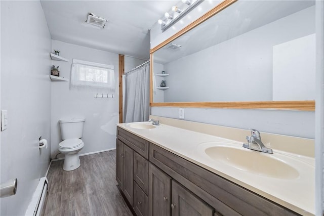 full bathroom with visible vents, toilet, wood finished floors, and a sink