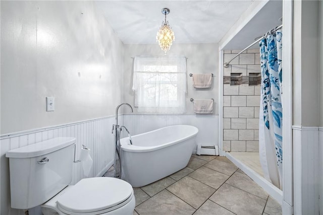 full bathroom featuring a baseboard heating unit, a wainscoted wall, toilet, a stall shower, and a soaking tub