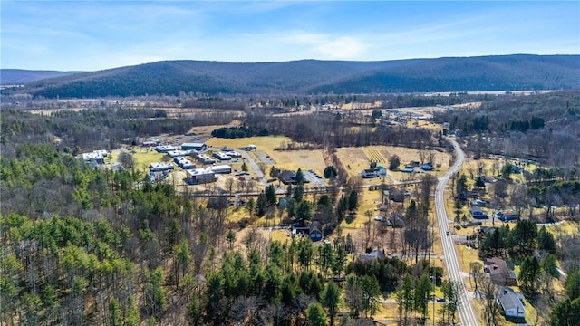 aerial view with a wooded view and a mountain view