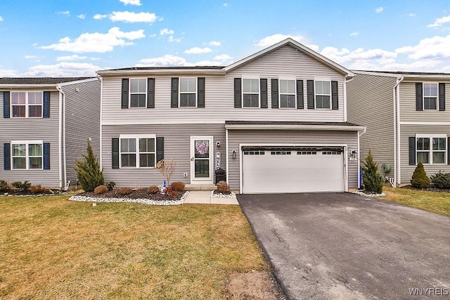 view of front facade with aphalt driveway, a garage, and a front yard