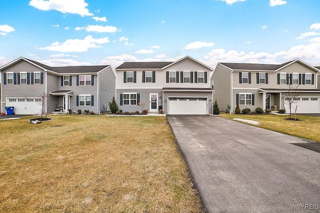 view of front of home with a front lawn, an attached garage, a residential view, and aphalt driveway