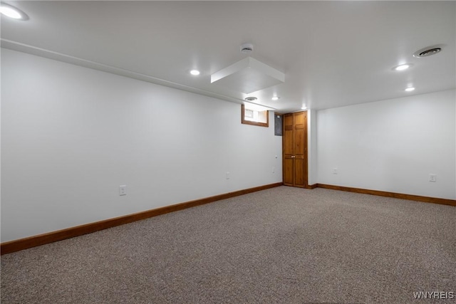 below grade area featuring recessed lighting, visible vents, light carpet, and baseboards